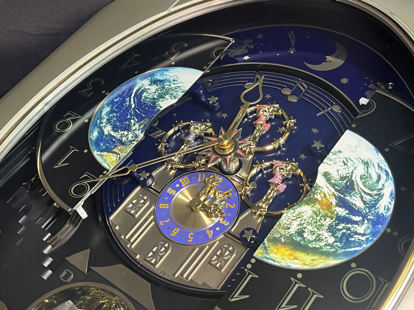 Rhythm “Peaceful Cosmos” Moving Earth Dial Magic Motion Musical Wall Clock with Popular Melodies - 4MH751AR19