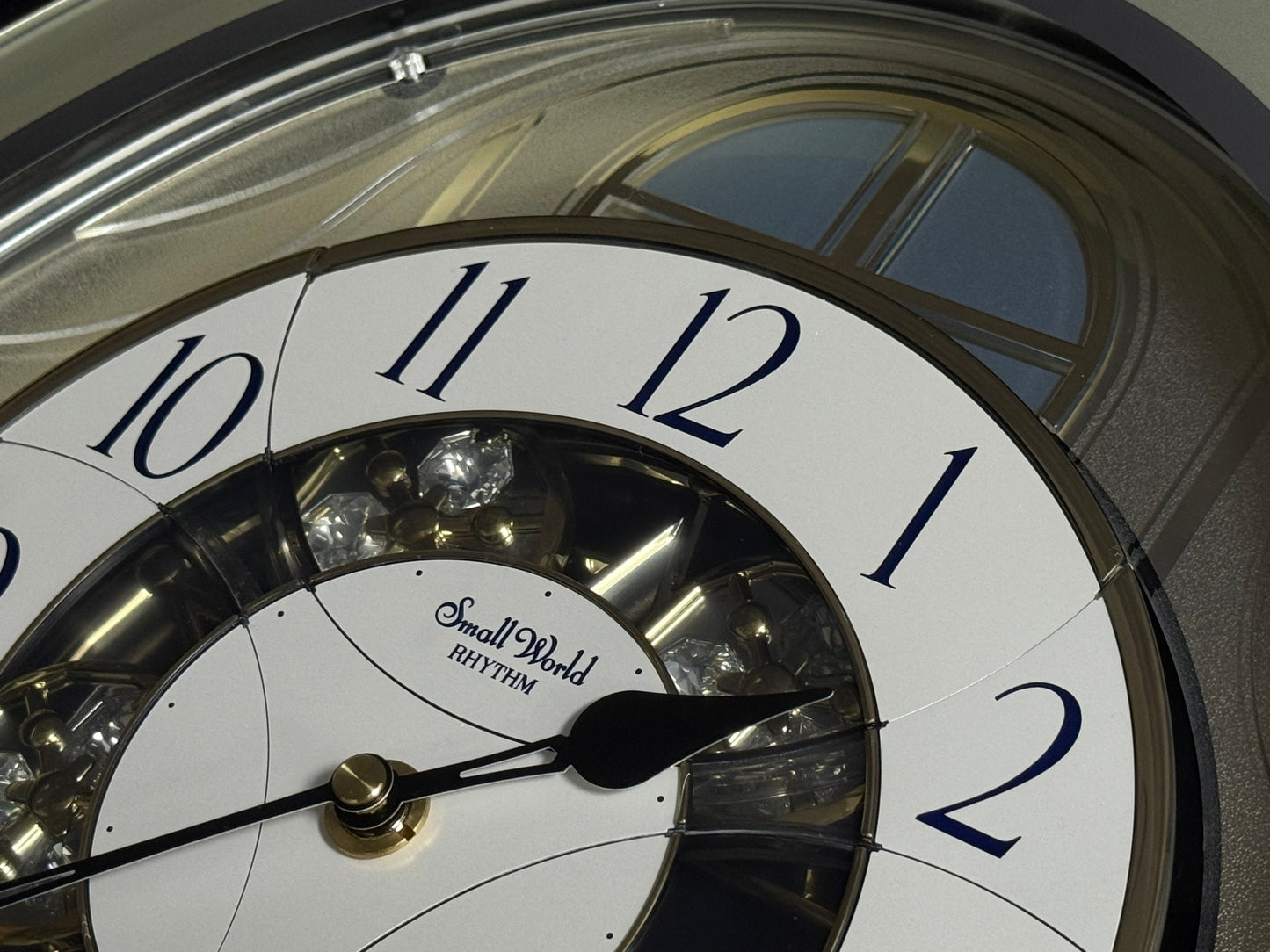 Rhythm "CTS Brilliance" Moving Dial Magic Motion Musical Wall Clock with Popular Melodies - 4MH787-R18