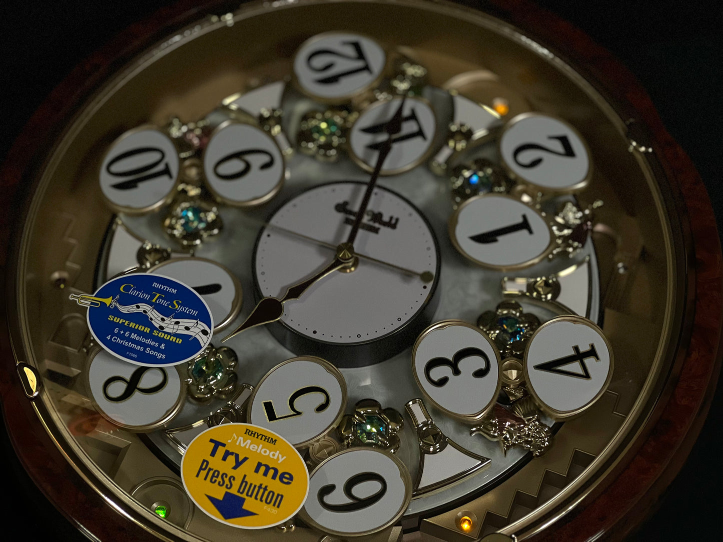 Rhythm “Woodgrain Blossom” Magic Motion Musical Wall Clock with Animated Moving Dial - 4MH828WD23