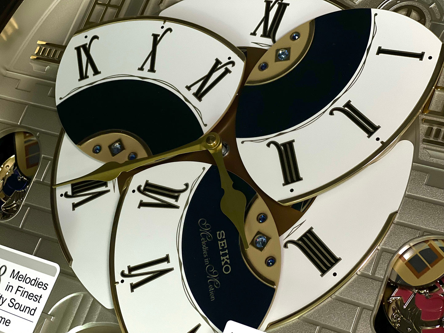 Seiko QXM371BRH “Castle Windows” Melodies in Motion Dancing Dial Musical Wall Clock