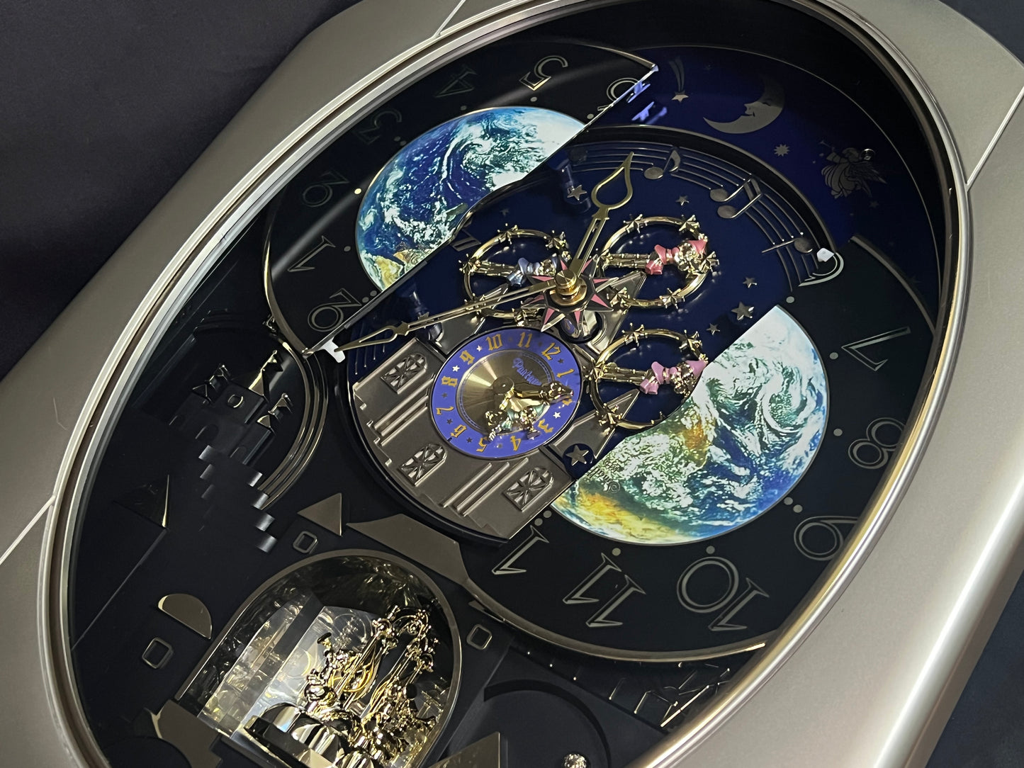 Rhythm “Peaceful Cosmos” Moving Earth Dial Magic Motion Musical Wall Clock with Popular Melodies - 4MH751AR19