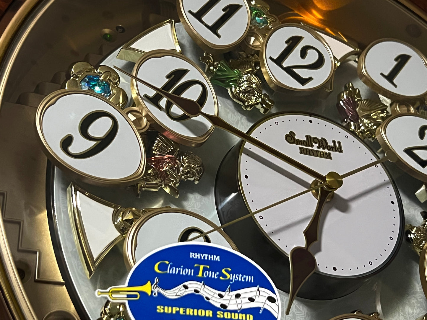 Rhythm “Woodgrain Blossom” Magic Motion Musical Wall Clock with Animated Moving Dial - 4MH828WD23