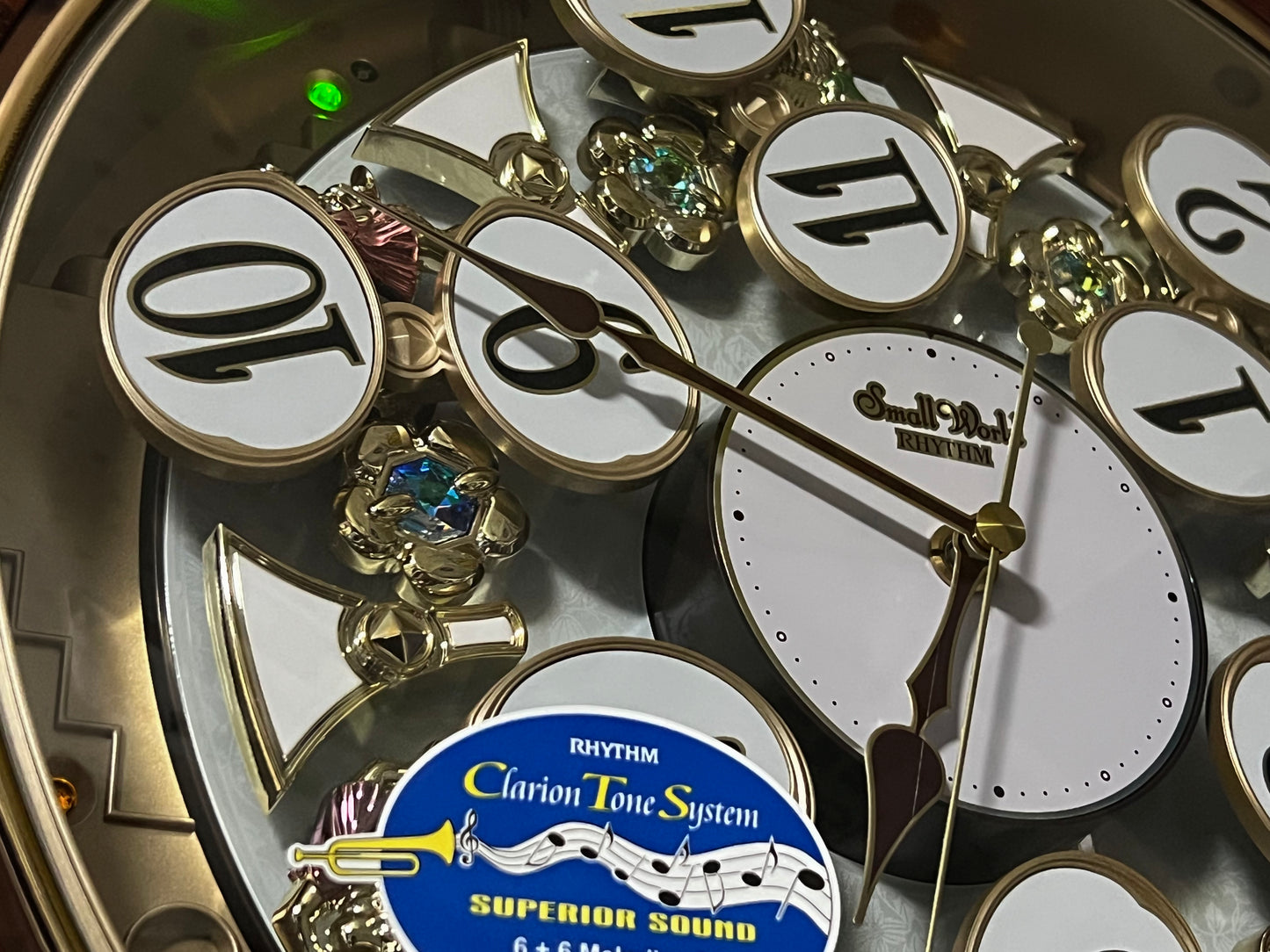 Rhythm “Woodgrain Blossom” Magic Motion Musical Wall Clock with Animated Moving Dial - 4MH828WD23