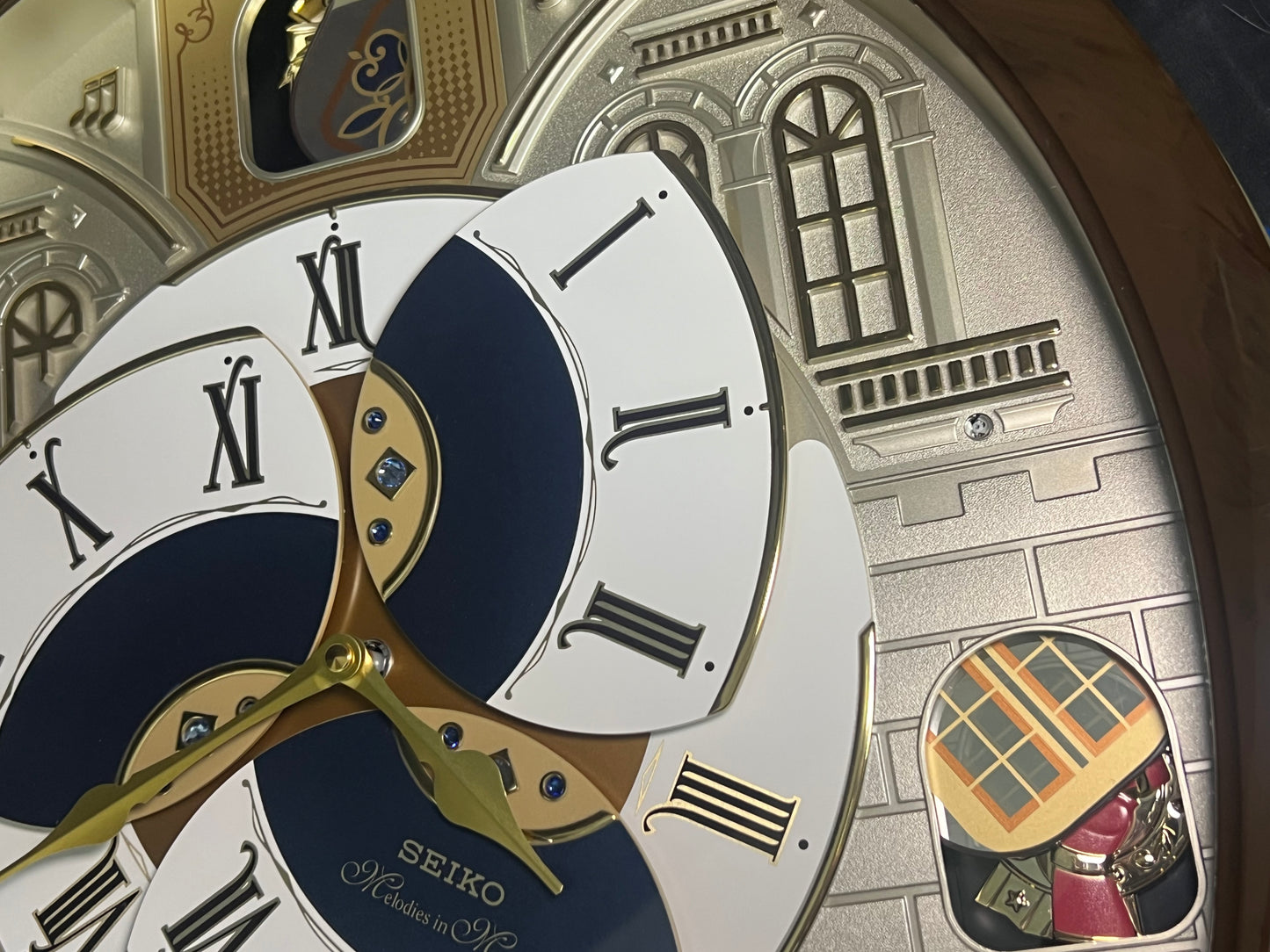 Seiko QXM371BRH “Castle Windows” Melodies in Motion Dancing Dial Musical Wall Clock