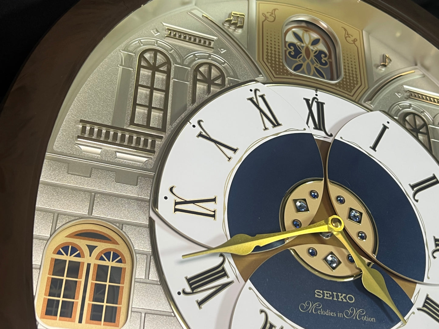 Seiko QXM371BRH “Castle Windows” Melodies in Motion Dancing Dial Musical Wall Clock