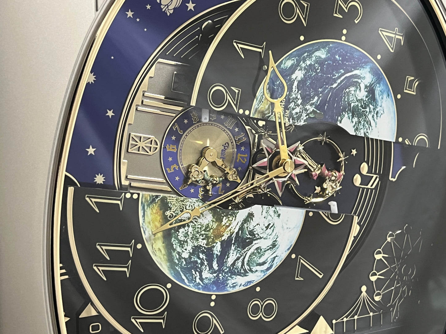 Rhythm “Peaceful Cosmos” Moving Earth Dial Magic Motion Musical Wall Clock with Popular Melodies - 4MH751AR19