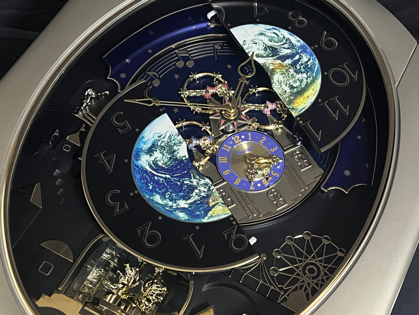 Rhythm “Peaceful Cosmos” Moving Earth Dial Magic Motion Musical Wall Clock with Popular Melodies - 4MH751AR19