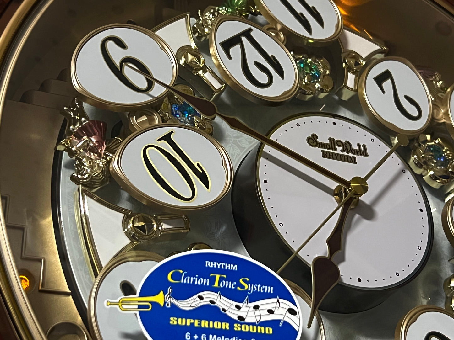 Rhythm “Woodgrain Blossom” Magic Motion Musical Wall Clock with Animated Moving Dial - 4MH828WD23