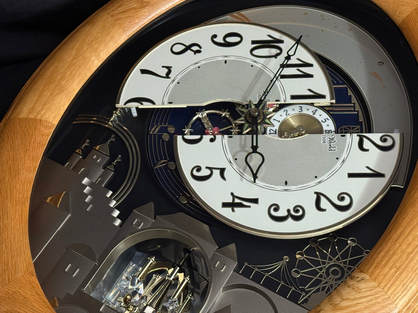 Rhythm "Timecracker Golden Oak" Moving Dial Magic Motion Musical Wooden Wall Clock with Popular Melodies - 4MH782-R07