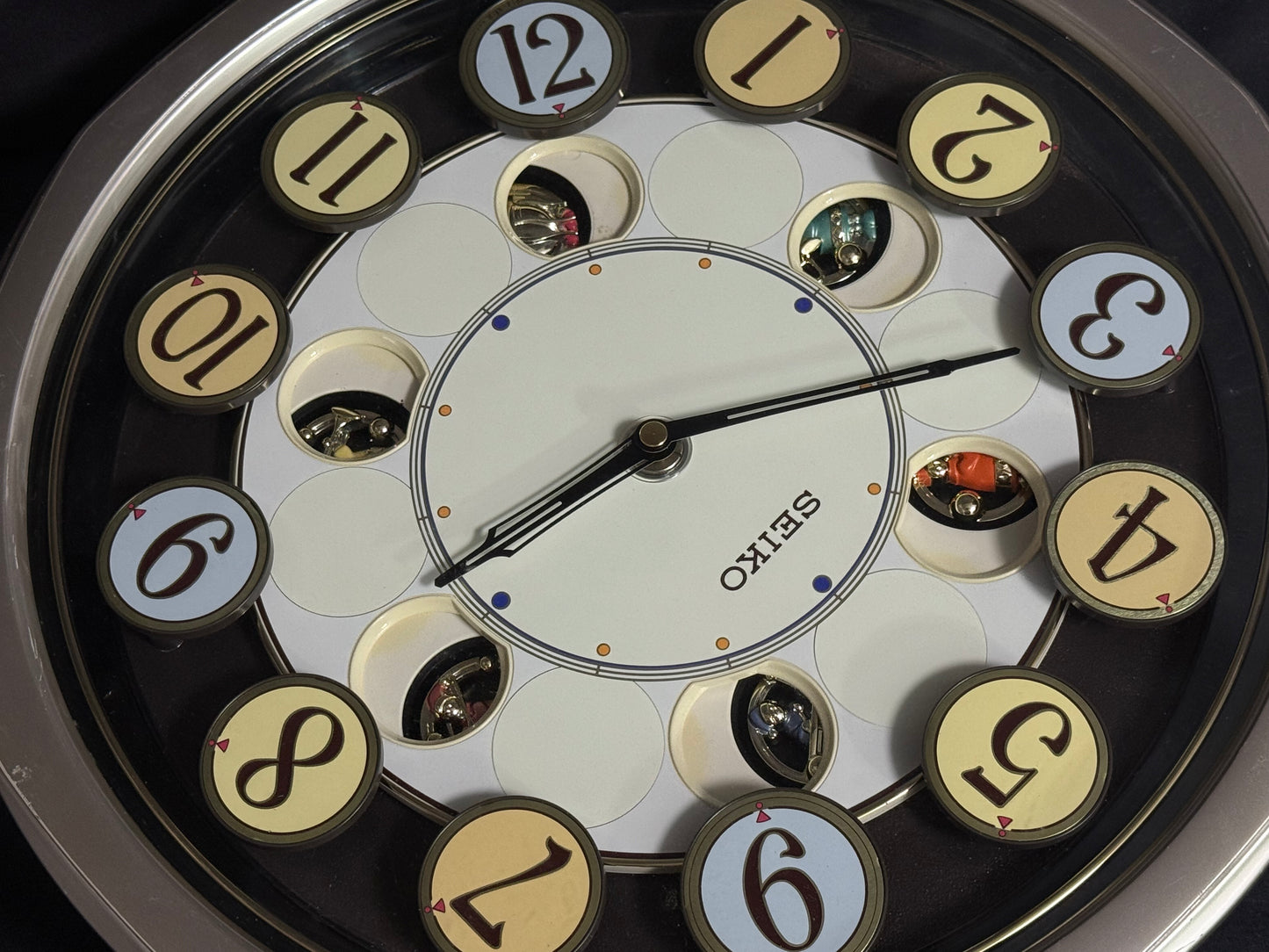 Seiko QXM106SRH "Twirling Numbers" Melodies in Motion Musical Wall Clock with Moving Dial