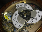Rhythm "Woodgrain Stars" Moving Dial Magic Motion Musical Wall Clock - 4MH843WS23