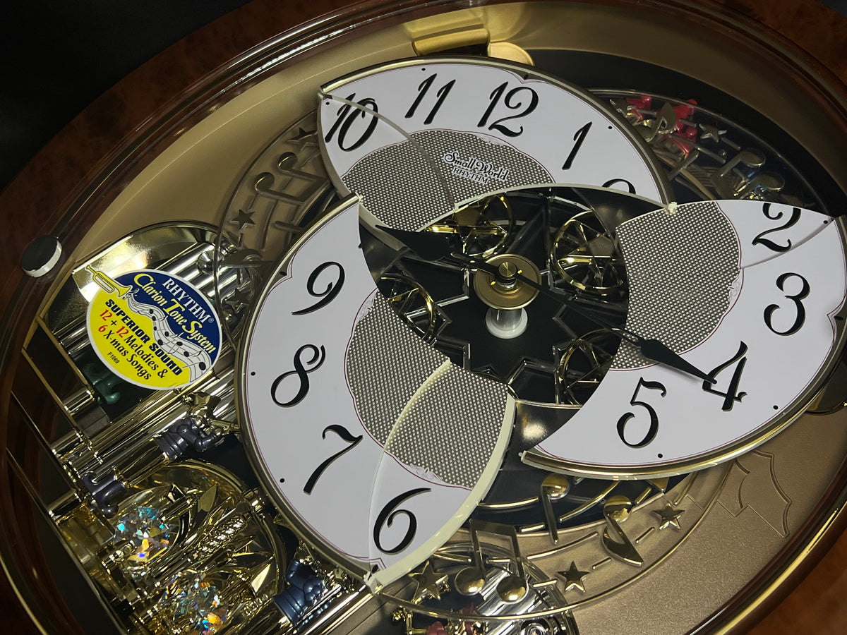 Rhythm "Woodgrain Stars" Moving Dial Magic Motion Musical Wall Clock - 4MH843WS23
