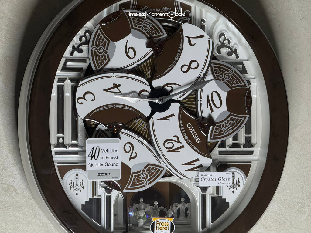 Seiko QXM615BRH “Snow Castle” Melodies in Motion Dancing Dial Musical Wall Clock with 40 Songs