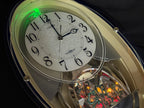 Citizen (Rhythm) "Pal Muse M482" Musical Motion Decorative Pendulum Wall Clock from Japan with LED Light Show - 4MN482-003