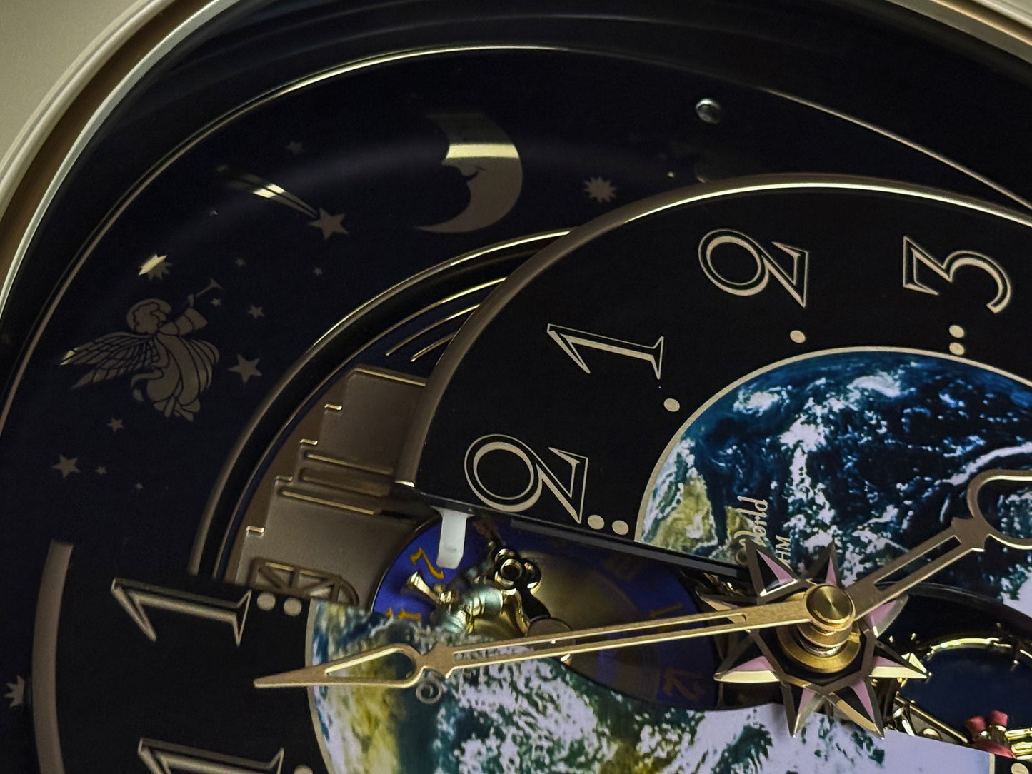 Rhythm “Peaceful Cosmos Entertainer” Moving Earth Dial Magic Motion Musical Wall Clock with Popular Melodies - 4MH839WB19