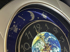 Rhythm “Peaceful Cosmos” Moving Earth Dial Magic Motion Musical Wall Clock with Popular Melodies - 4MH751AR19