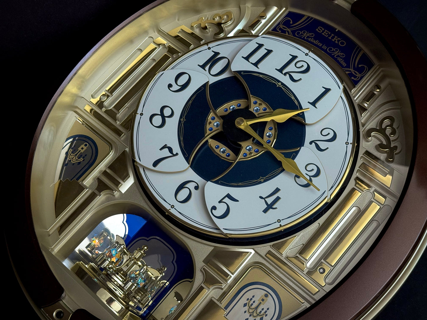 Seiko QXM356BRH "Golden Pillars" Melodies in Motion Dancing Dial Musical Wall Clock