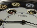 Seiko QXM106SRH "Twirling Numbers" Melodies in Motion Musical Wall Clock with Moving Dial