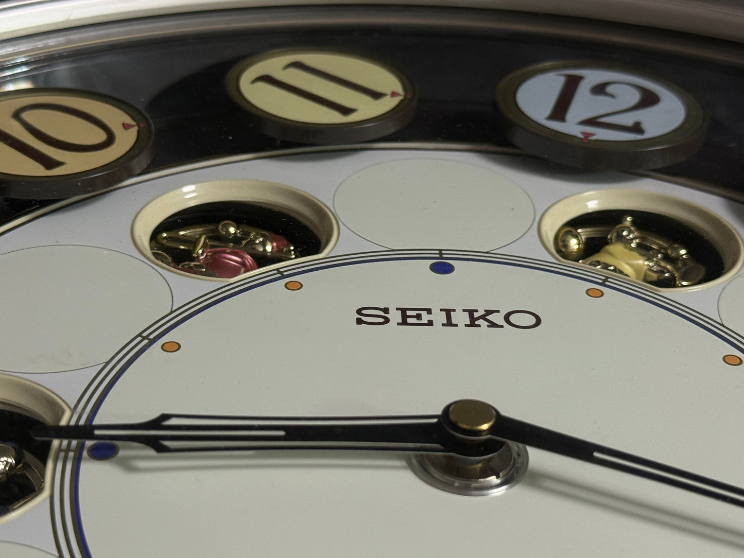 Seiko QXM106SRH "Twirling Numbers" Melodies in Motion Musical Wall Clock with Moving Dial