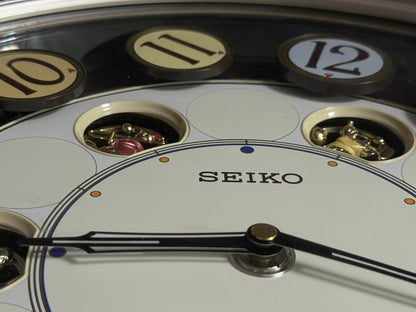 Seiko QXM106SRH "Twirling Numbers" Melodies in Motion Musical Wall Clock with Moving Dial