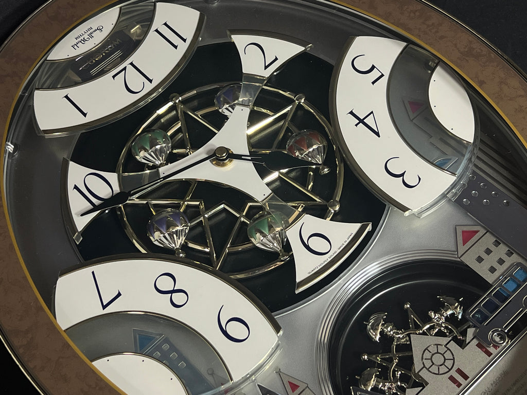 Rhythm “Tri-Cracker” Moving Dial Magic Motion Musical Wall Clock with Popular Melodies - 4MH759NR06