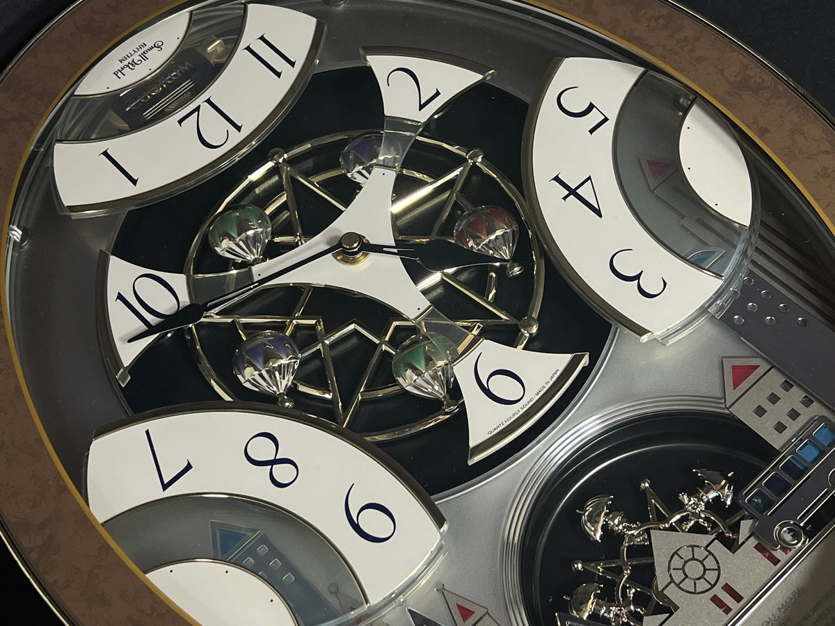 Rhythm “Tri-Cracker” Moving Dial Magic Motion Musical Wall Clock with Popular Melodies - 4MH759NR06