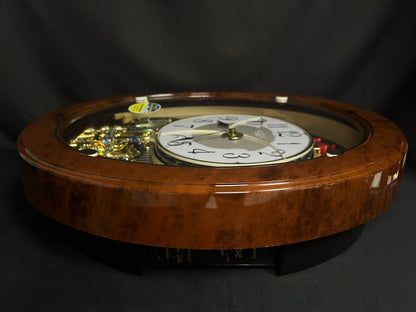 Rhythm "Woodgrain Stars" Moving Dial Magic Motion Musical Wall Clock - 4MH843WS23