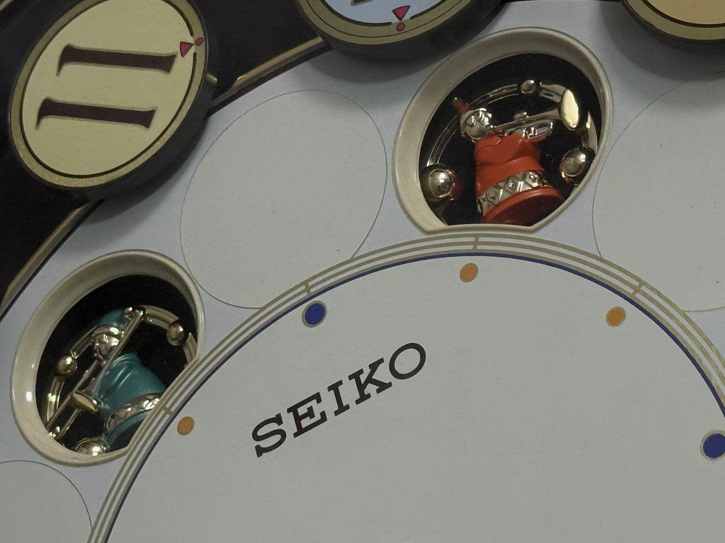 Seiko QXM106SRH "Twirling Numbers" Melodies in Motion Musical Wall Clock with Moving Dial