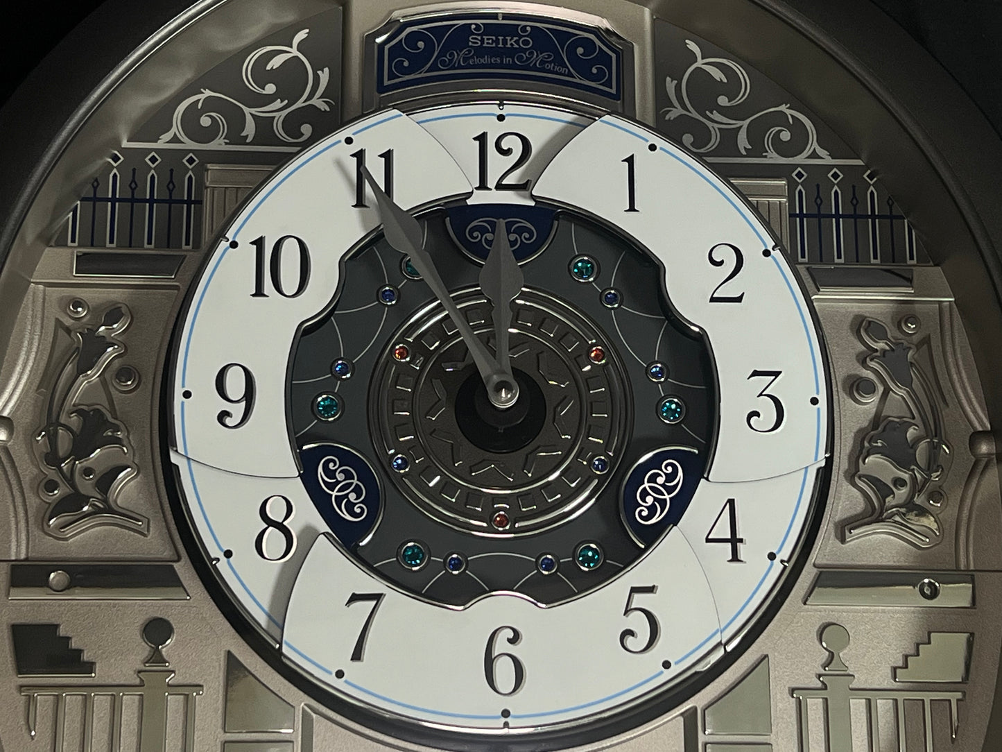 Seiko QXM366SRH “Musical Motifs” Melodies in Motion Dancing Dial Musical Wall Clock