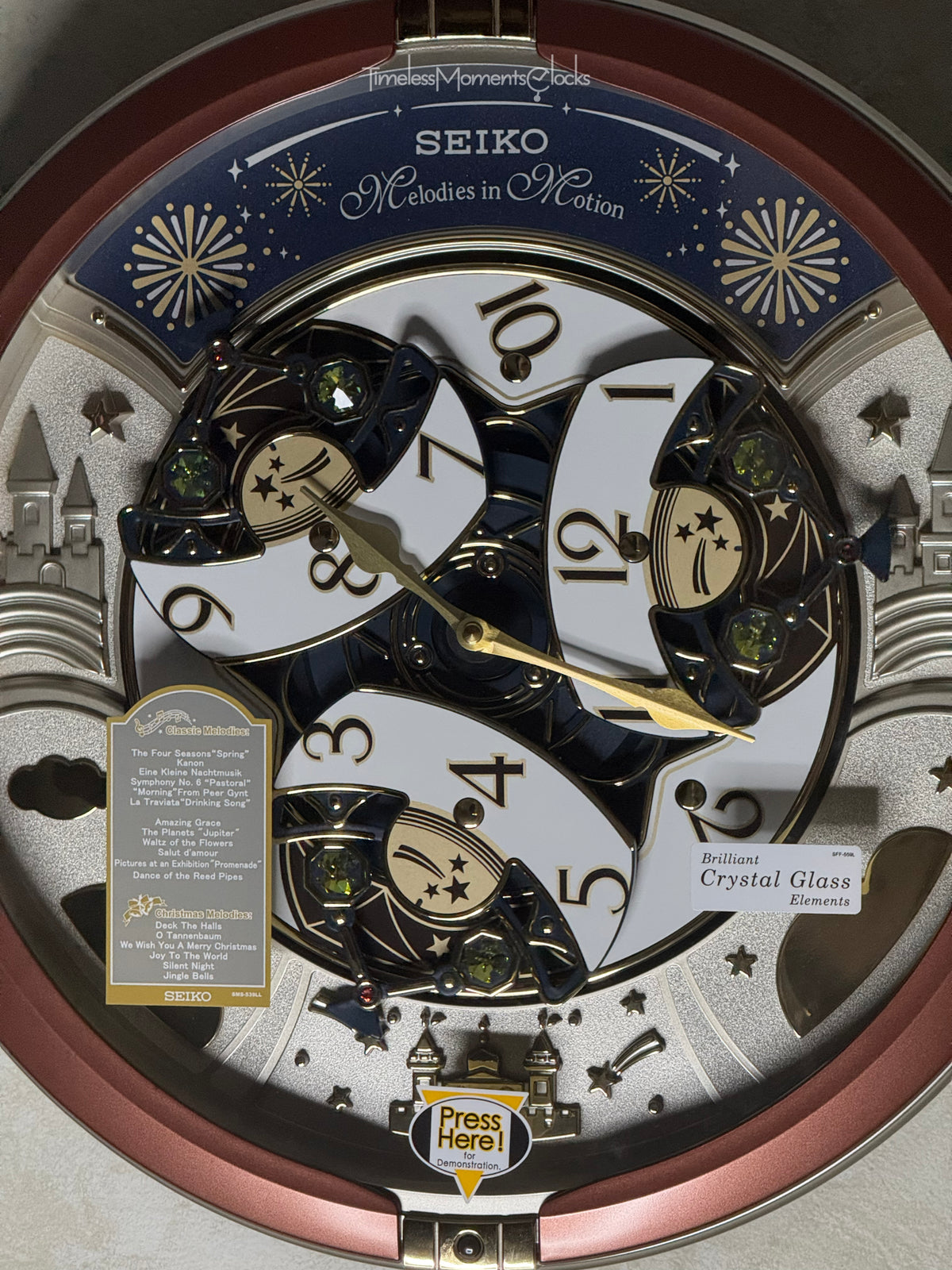 Seiko QXM378BRH “Castle Night” Melodies in Motion Dancing Dial Musical Wall Clock with 18 Songs