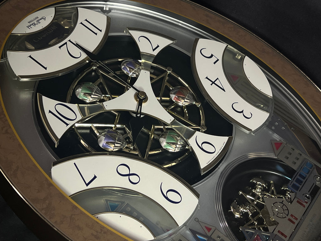 Rhythm “Tri-Cracker” Moving Dial Magic Motion Musical Wall Clock with Popular Melodies - 4MH759NR06