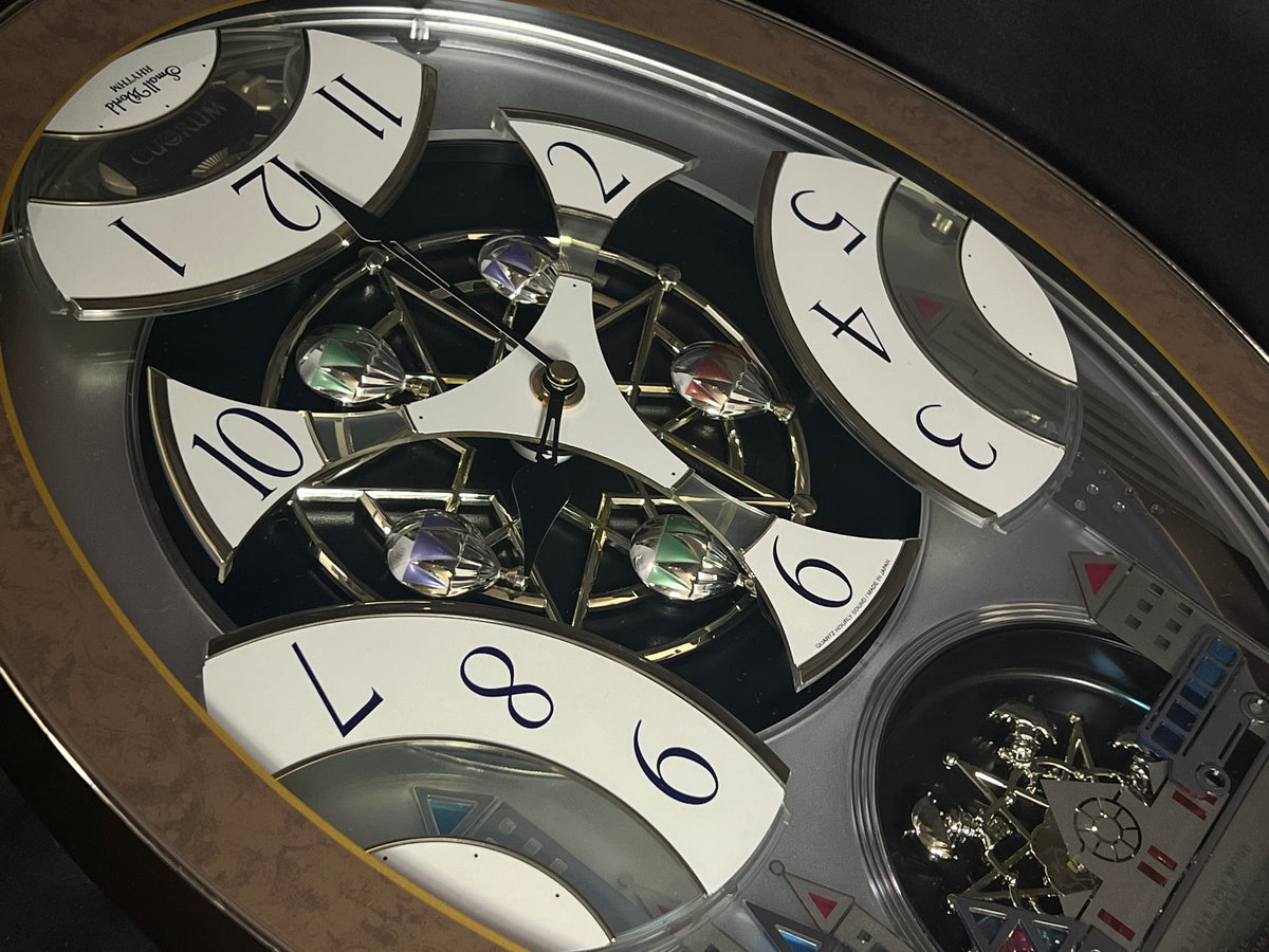 Rhythm “Tri-Cracker” Moving Dial Magic Motion Musical Wall Clock with Popular Melodies - 4MH759NR06