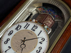 Seiko QXM123BRH "Broadway Showtunes Dropping Dial" Melodies in Motion Musical Moving Wall Clock with Popular Melodies