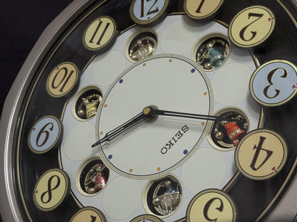 Seiko QXM106SRH "Twirling Numbers" Melodies in Motion Musical Wall Clock with Moving Dial