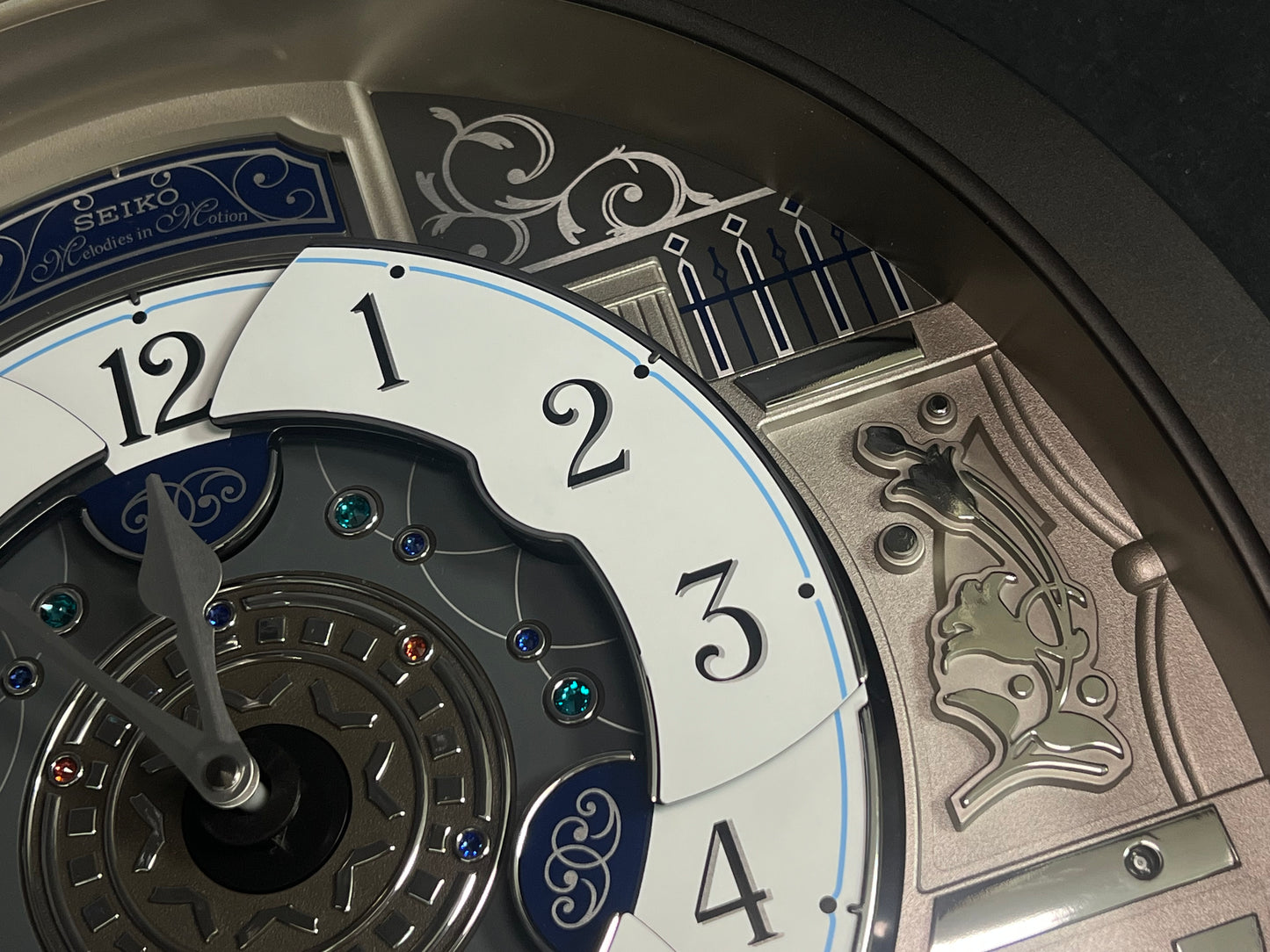Seiko QXM366SRH “Musical Motifs” Melodies in Motion Dancing Dial Musical Wall Clock