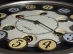 Seiko QXM106SRH "Twirling Numbers" Melodies in Motion Musical Wall Clock with Moving Dial