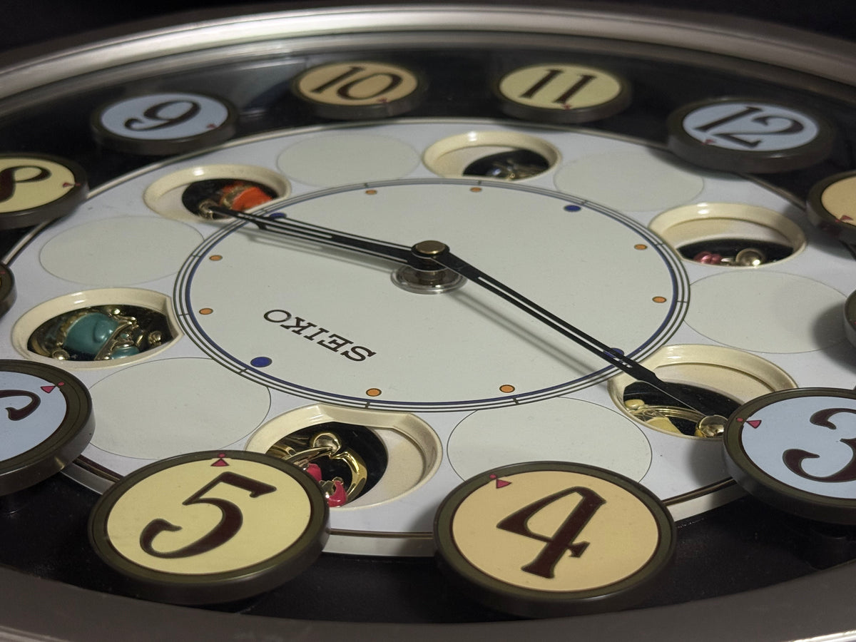 Seiko QXM106SRH "Twirling Numbers" Melodies in Motion Musical Wall Clock with Moving Dial