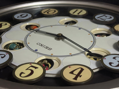 Seiko QXM106SRH "Twirling Numbers" Melodies in Motion Musical Wall Clock with Moving Dial