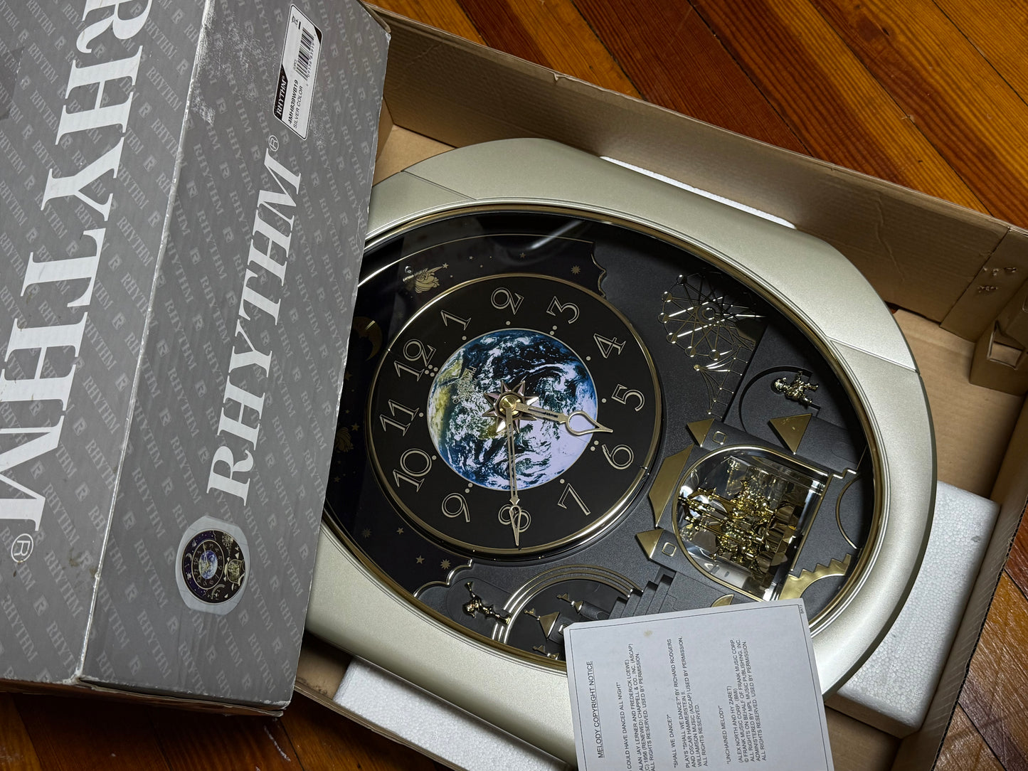 Rhythm “Peaceful Cosmos Entertainer” Moving Earth Dial Magic Motion Musical Wall Clock with Popular Melodies - 4MH839WB19