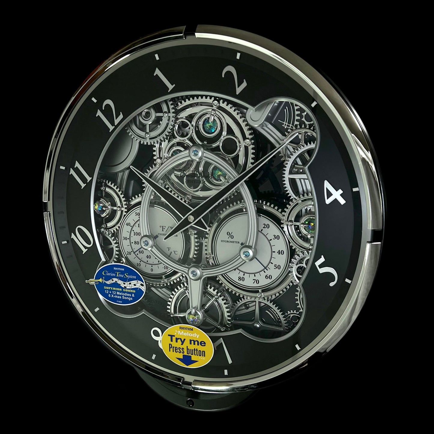 Rhythm “Chronograph (Black/Silver)” Skeletonized Dial Magic Motion Musical Wall Clock with Moving Gears - 4MH442WU08