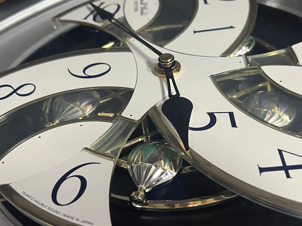 Rhythm “Tri-Cracker” Moving Dial Magic Motion Musical Wall Clock with Popular Melodies - 4MH759NR06