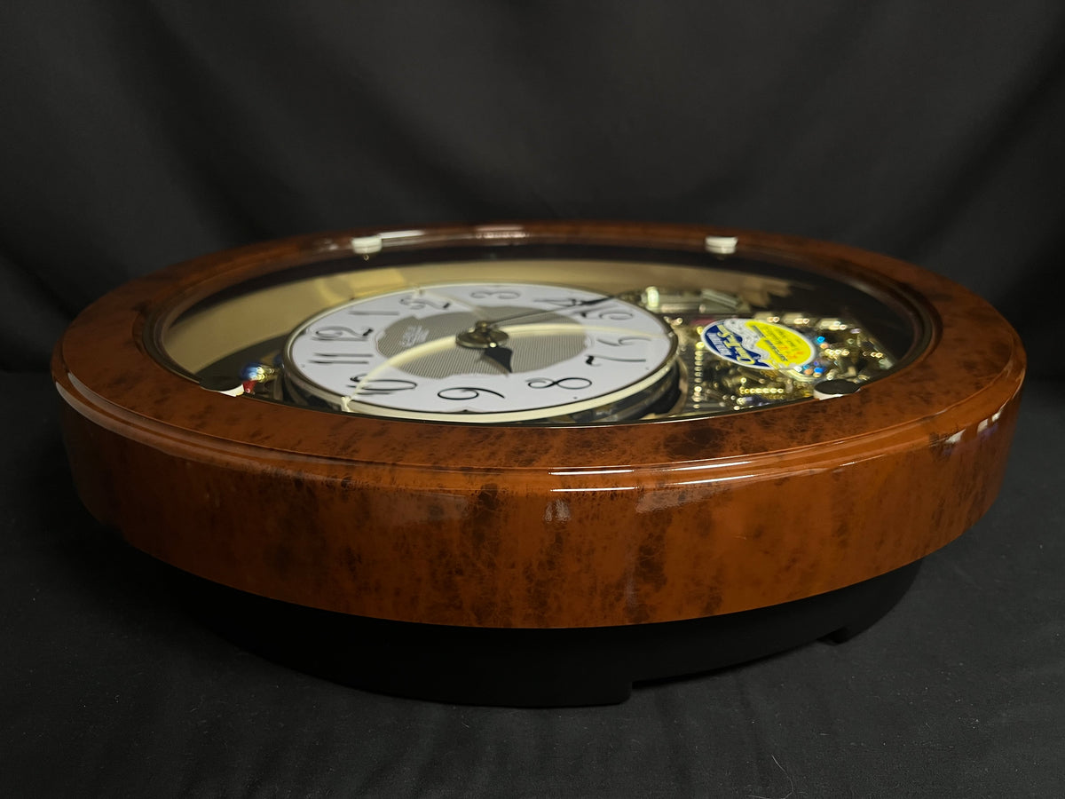 Rhythm "Woodgrain Stars" Moving Dial Magic Motion Musical Wall Clock - 4MH843WS23