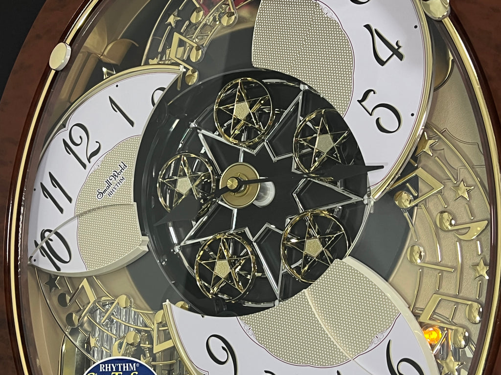 Rhythm "Woodgrain Stars" Moving Dial Magic Motion Musical Wall Clock - 4MH843WS23