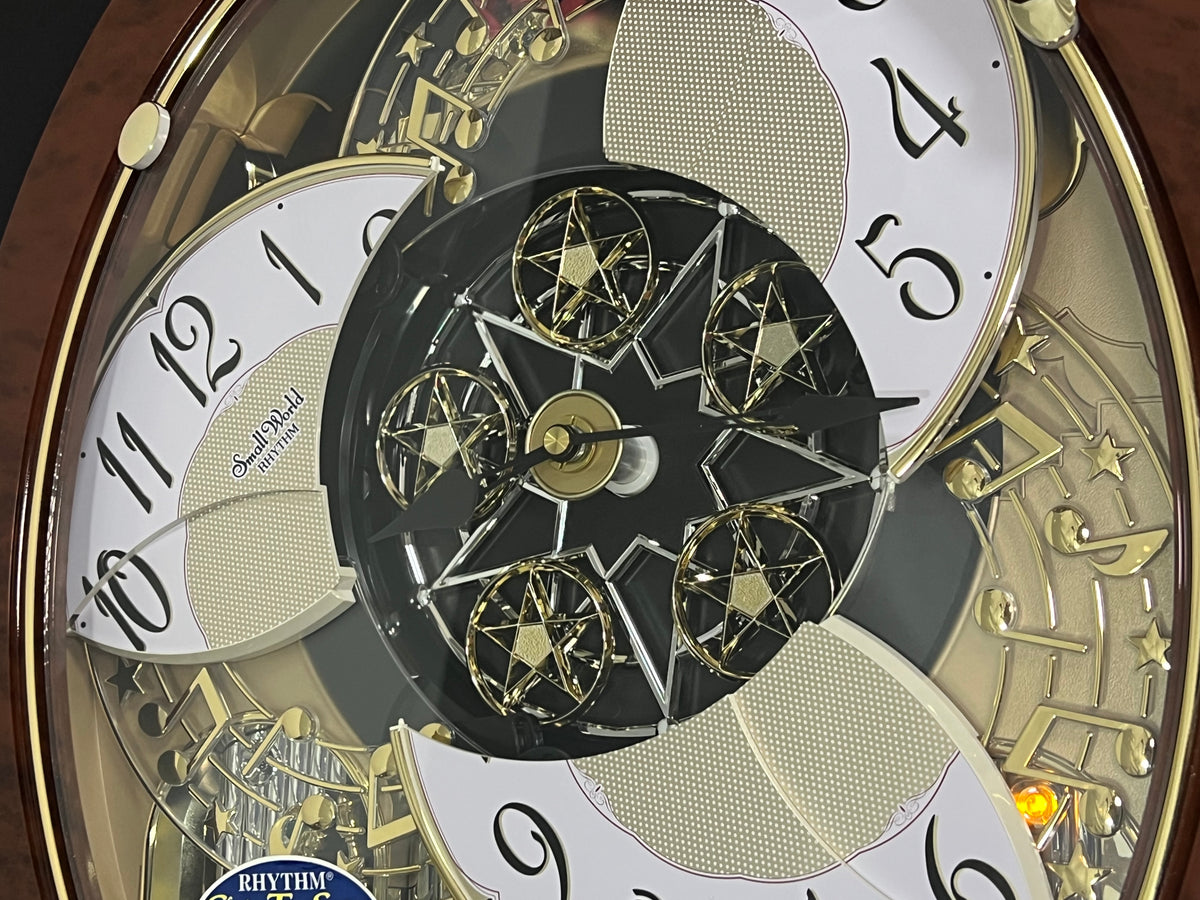 Rhythm "Woodgrain Stars" Moving Dial Magic Motion Musical Wall Clock - 4MH843WS23