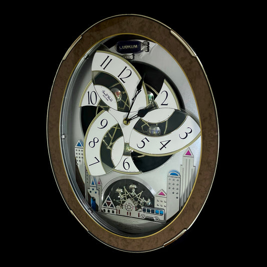 Rhythm “Tri-Cracker” Magic Motion Musical Wall Clock with Moving Dial and Balloons - 4MH759NR06