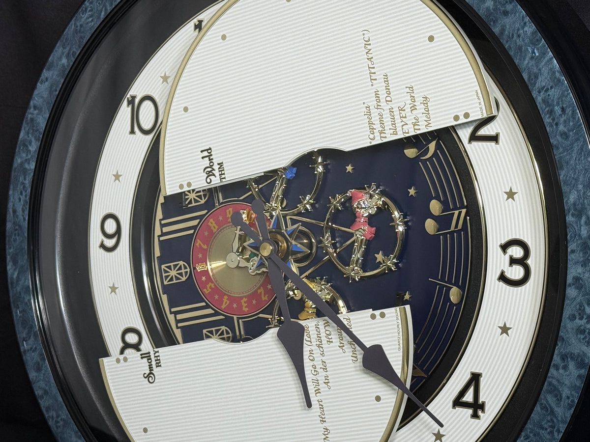 Rhythm “Small World Partage Home (Blue)” Moving Dial Magic Motion Musical Wall Clock with Popular Melodies - 4MH754RH04
