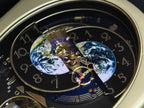 Rhythm “Peaceful Cosmos Entertainer” Moving Earth Dial Magic Motion Musical Wall Clock with Popular Melodies - 4MH839WB19