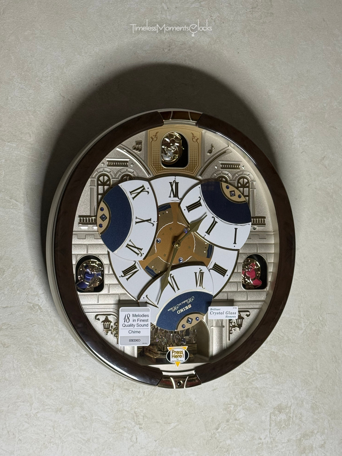 Seiko QXM371BRH “Castle Windows” Melodies in Motion Dancing Dial Musical Wall Clock with 19 Songs