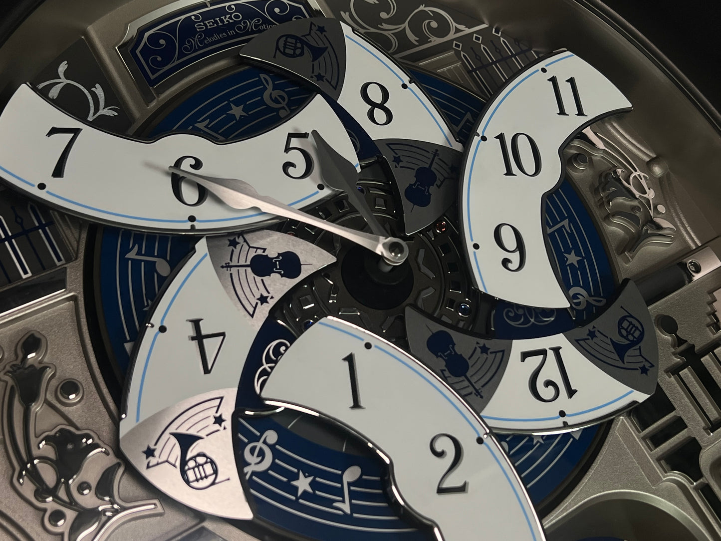 Seiko QXM366SRH “Musical Motifs” Melodies in Motion Dancing Dial Musical Wall Clock