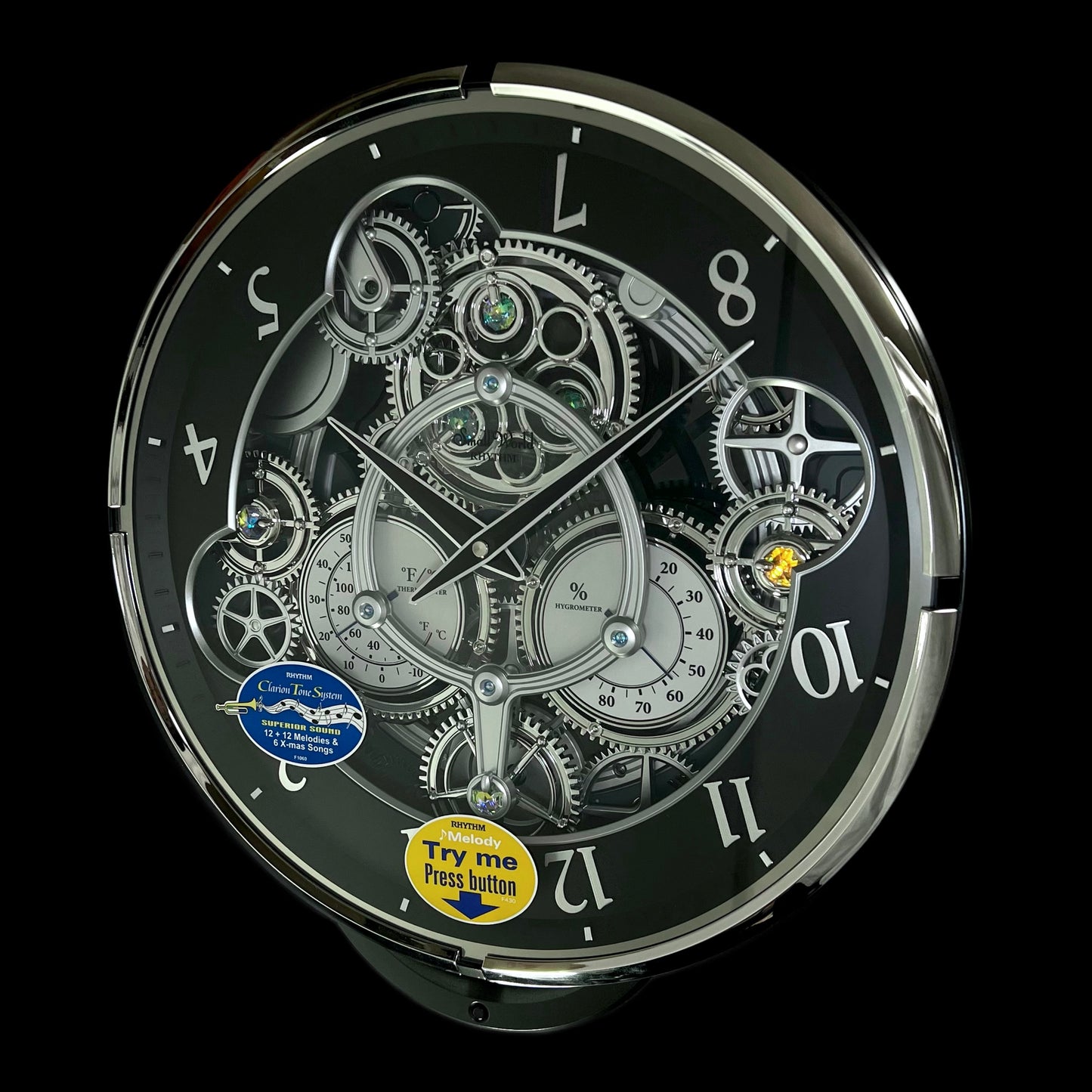 Rhythm “Chronograph (Black/Silver)” Skeletonized Dial Magic Motion Musical Wall Clock with Moving Gears - 4MH442WU08